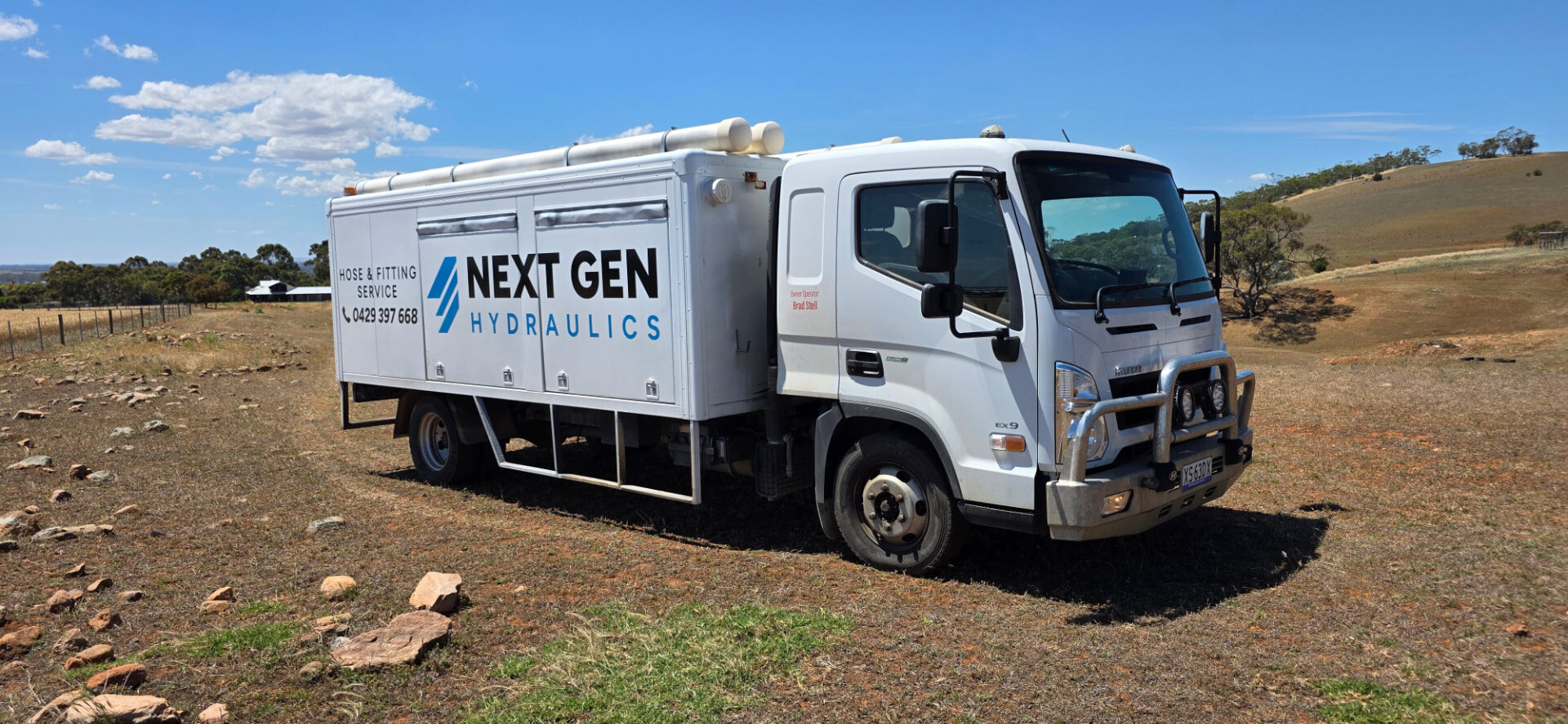 Next Gen Hydraulics service truck parked on a hilltop paddock track outside Adelaide at dusk