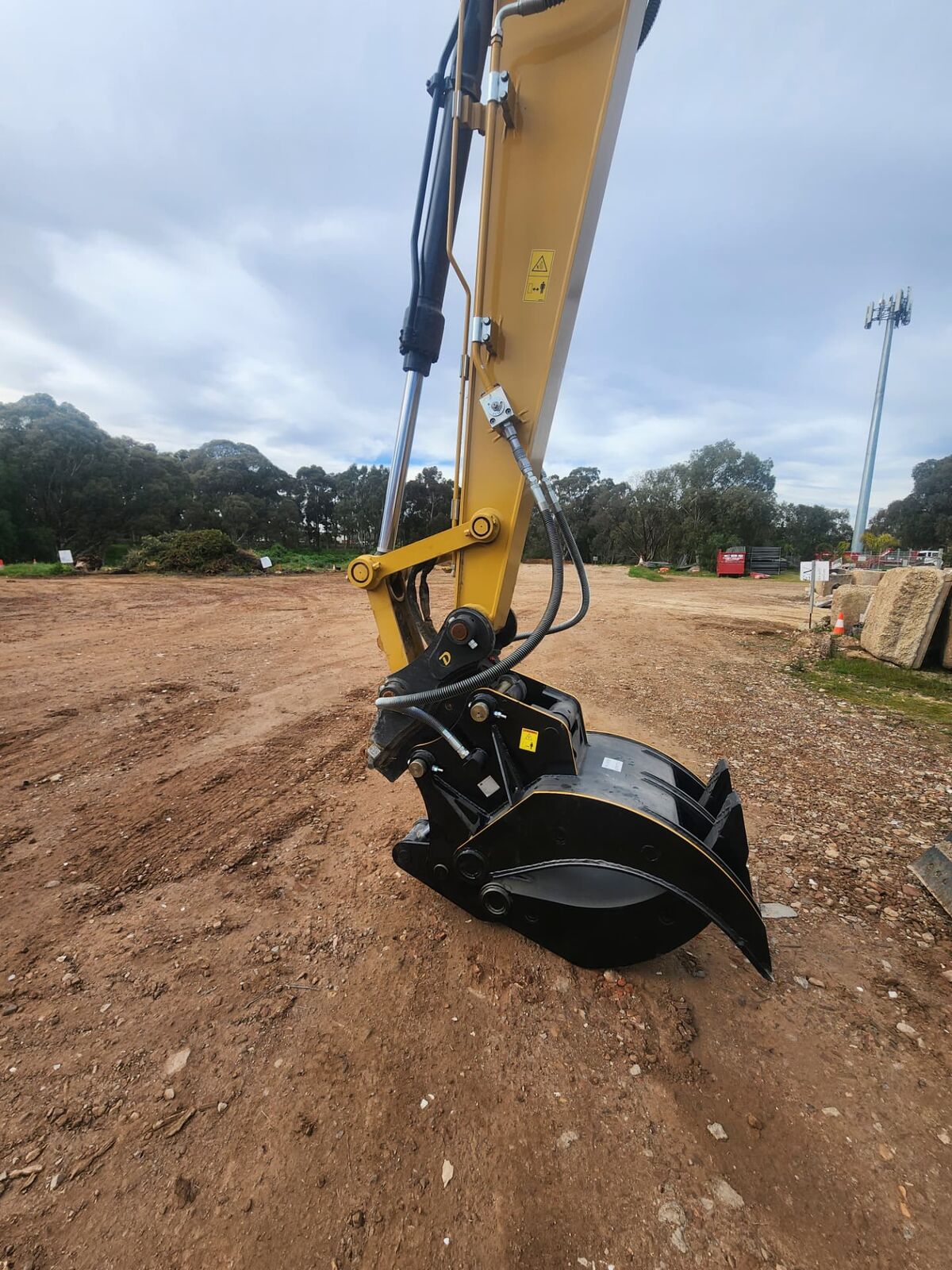 Excavator on an Adelaide earthmoving site with its boom hoses being repaired in the field